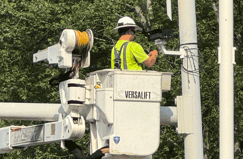 Worker installs SIMPL at an intersection in Charlotte